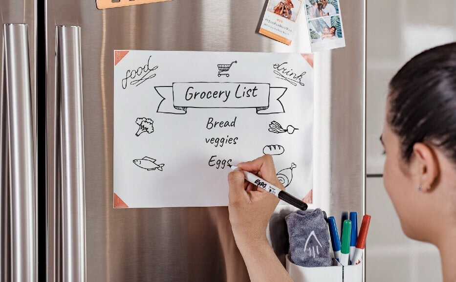 woman writing grocery list on Think Board X