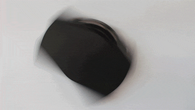 A GIF of a person spinning a Rocketbook and removing a pen from the Pen Station