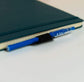 The Pen Station attached to a Rocketbook reusable notebook