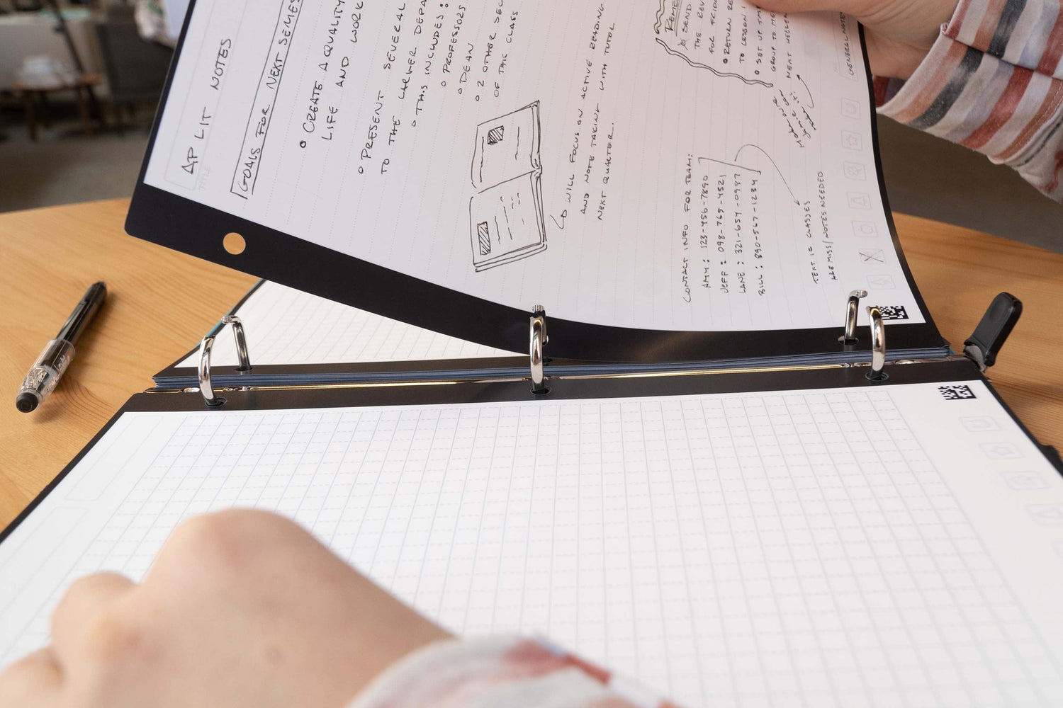 A second view of a person removing a sheet of Filler Paper from a 3-ring binder